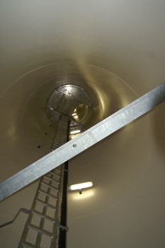 Inside view and access ladder in tubular steel tower.